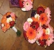 Bouquets of pink, orange, and red flowers on a tiled floor