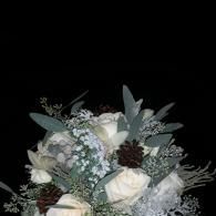 Neutral-toned bouquet of white roses, eucalyptus, and berries on a black background