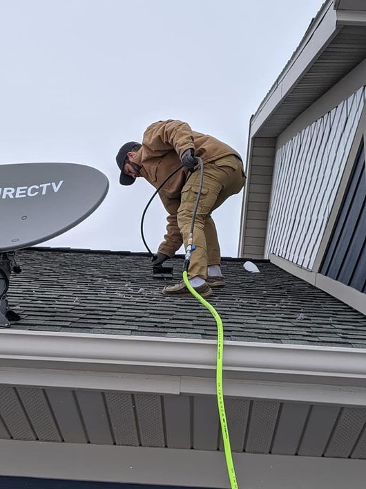 An air duct cleaning company is working on a cleaning from the roof of a house.