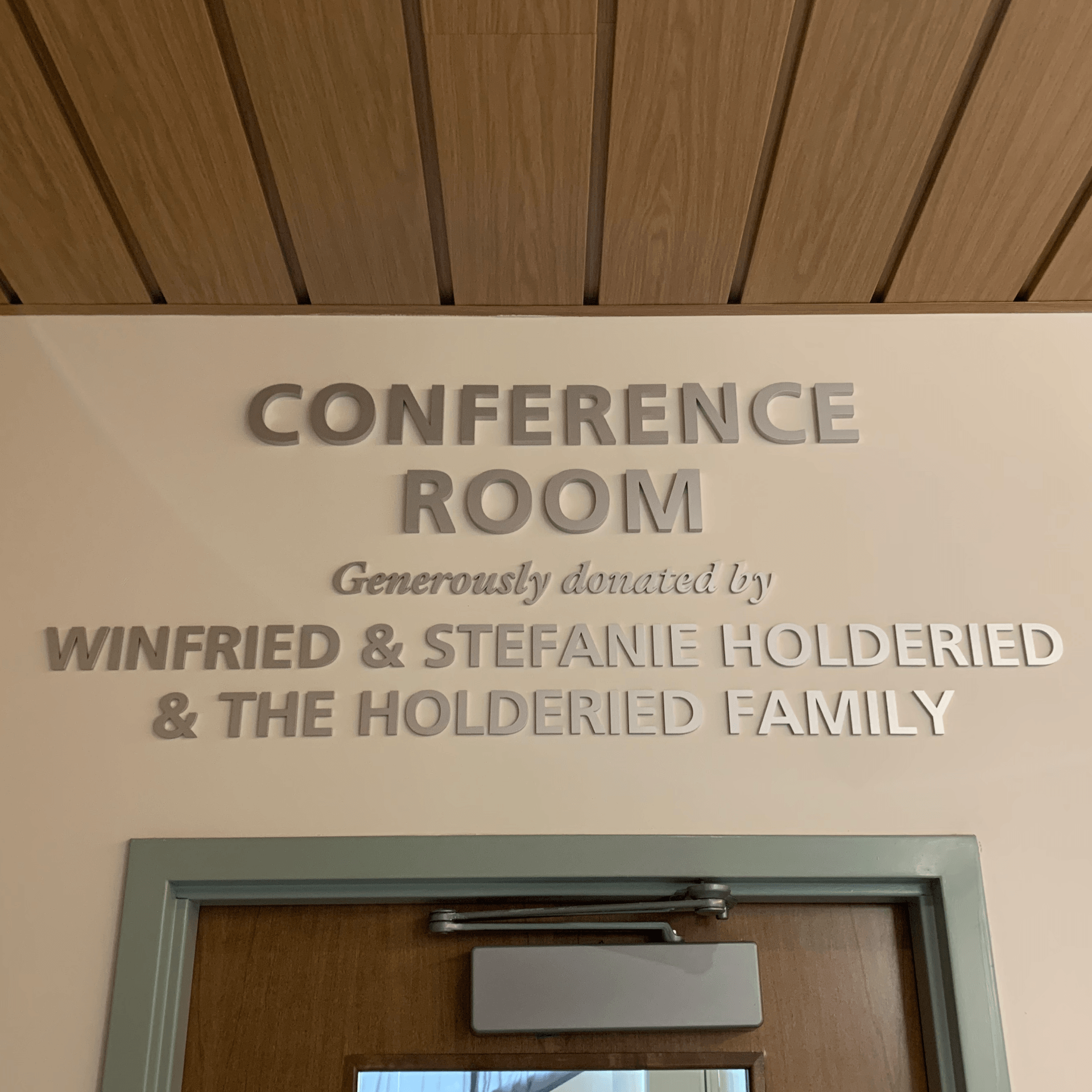 A conference room sign that reads