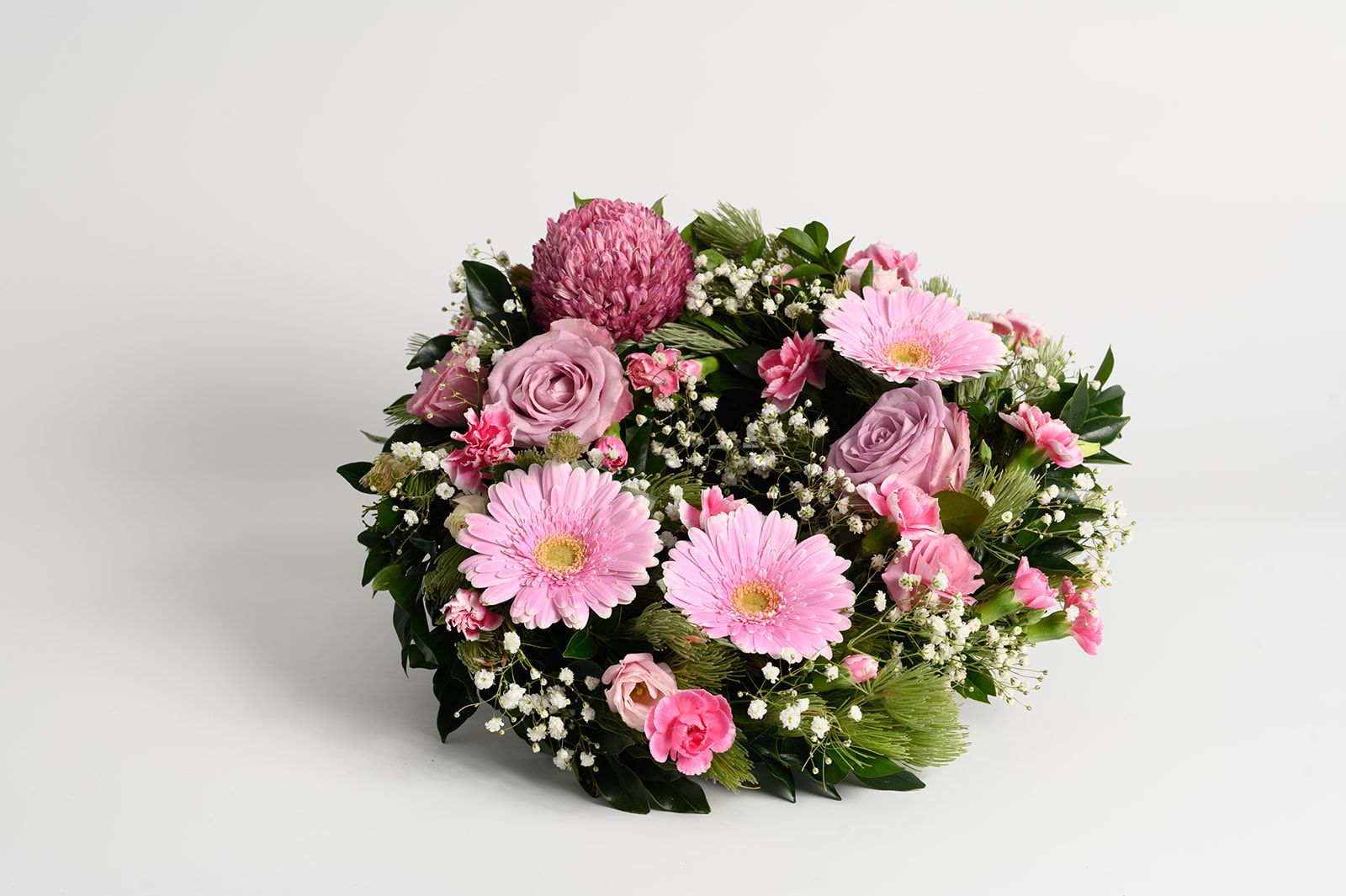 Pink and white mixed flower wreath on a white background