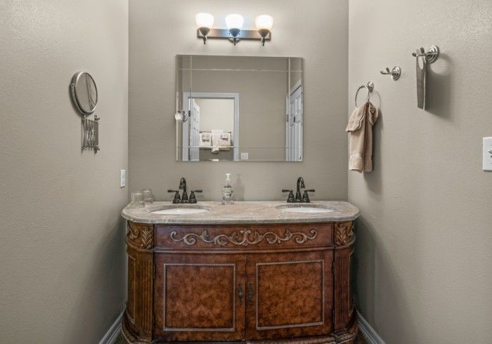 A bathroom with two sinks and a mirror.