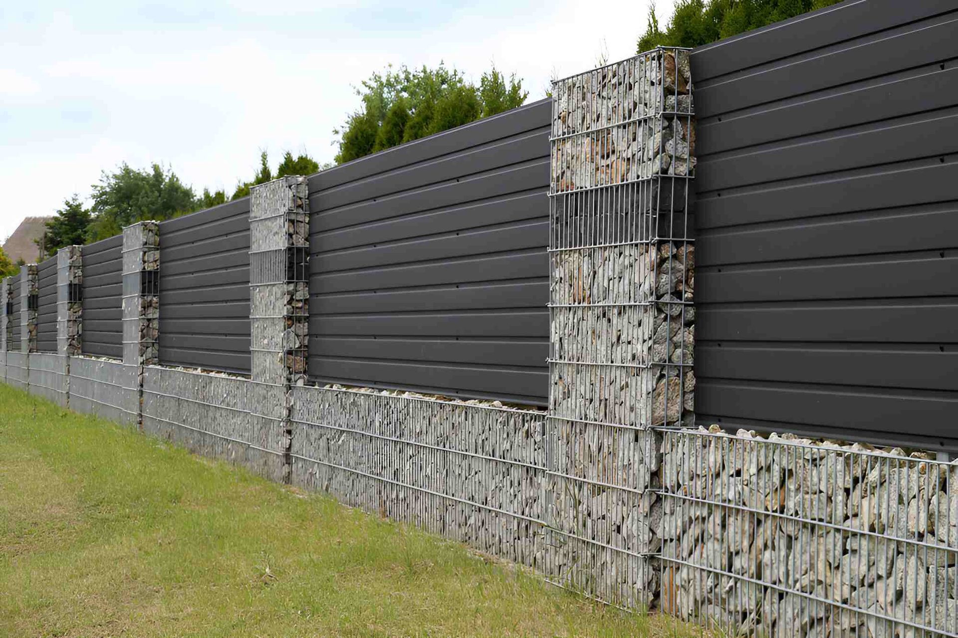 Gray Horizontal-slat Fence With Gabion Stone Columns and Base — Affordable Underpinning Solutions In Campbelltown, NSW