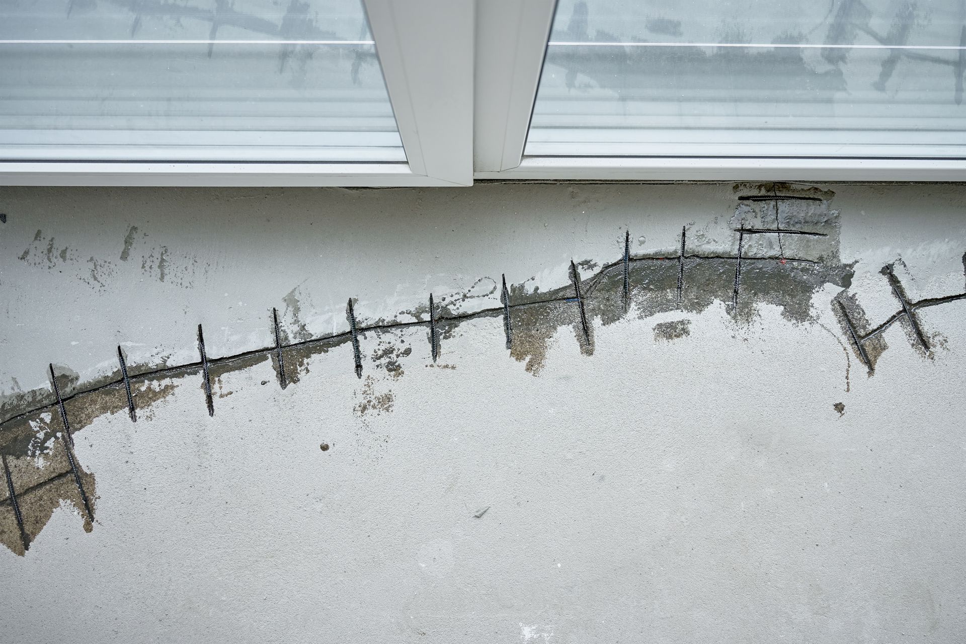 Damaged Concrete Wall, Showing Exposed Rebar, Near a Window — Affordable Underpinning Solutions In Shell Cove, NSW