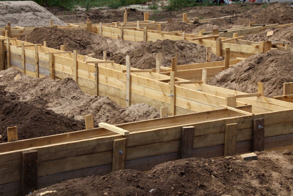 A Pile Of Dirt And Wooden Blocks In A Construction Site — Affordable Underpinning Solutions In Jervis Bay, NSW