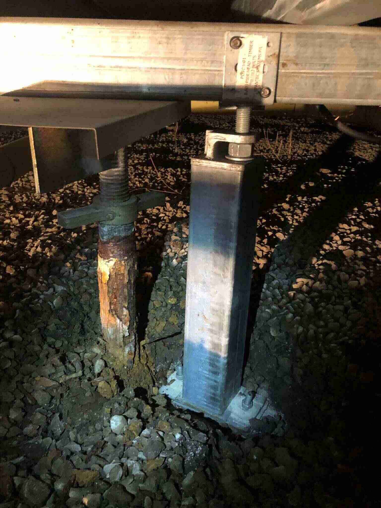 A Metal Post Is Sitting On Top Of A Pile Of Dirt — Affordable Underpinning Solutions In Shell Cove, NSW