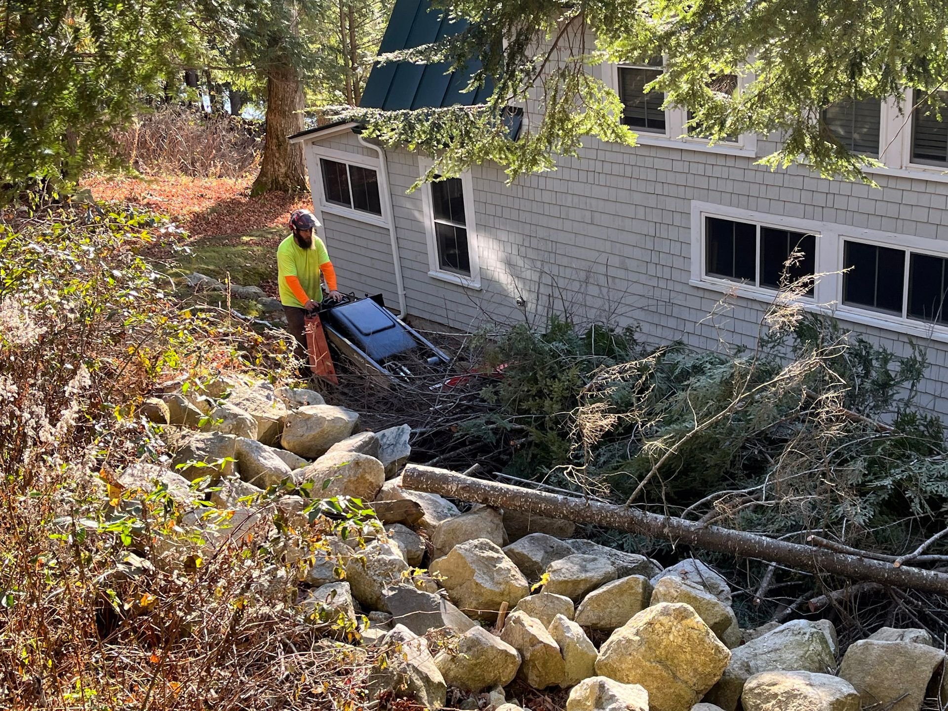 NEK Tree Workz cleaning up after removing a tree that was a safety concern to the home owners