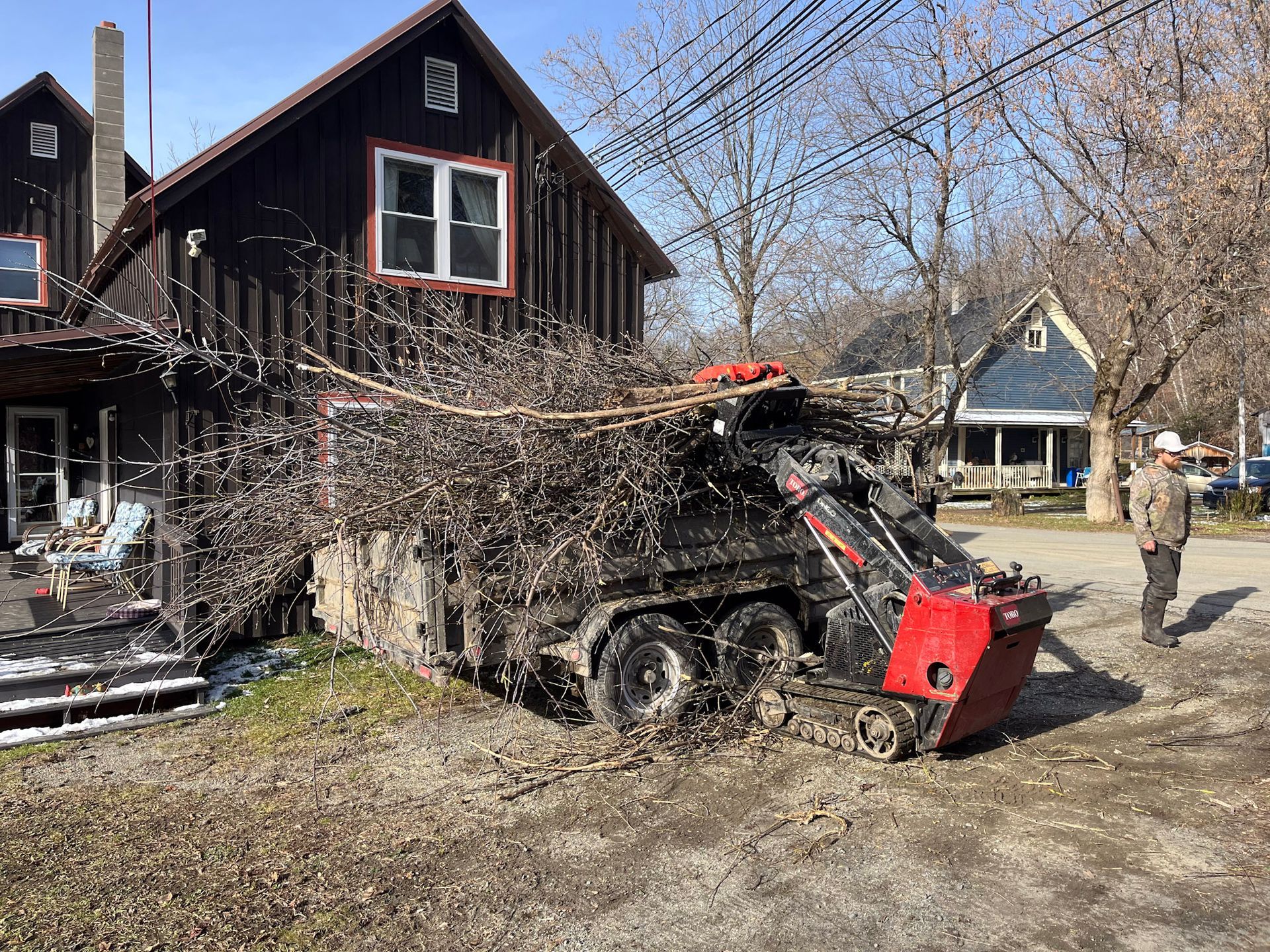 NEK Tree Workz equipment cleaning up after a tree removal