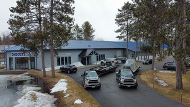 Flatbed truck hauling a pontoon boat