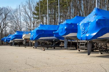 Shrink-wrapped boats in outdoor storage