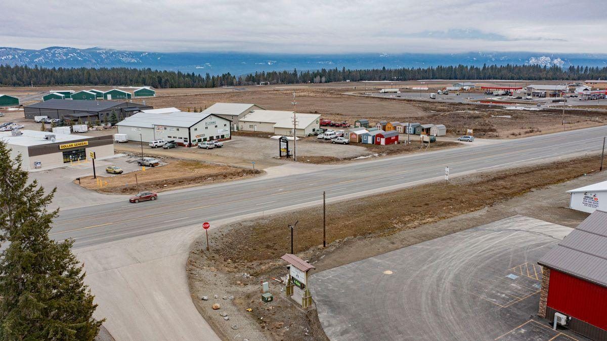 Aerial view of the Highway 95 commercial corridor at Three Mile on the North Bench, with the Selkirk Mountains beyond
