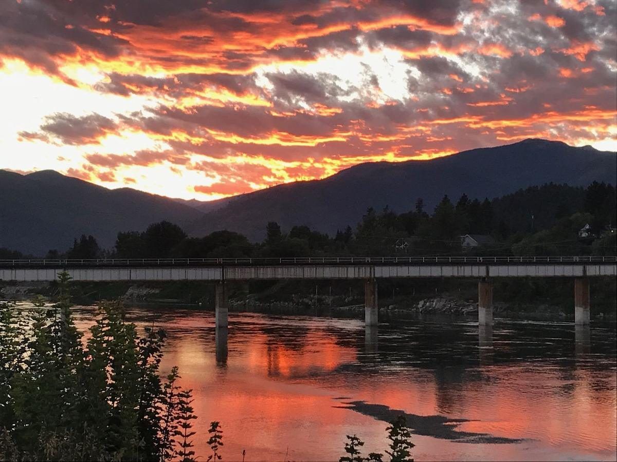 A fiery sunset over the Kootenai River and the railroad bridge at Bonners Ferry