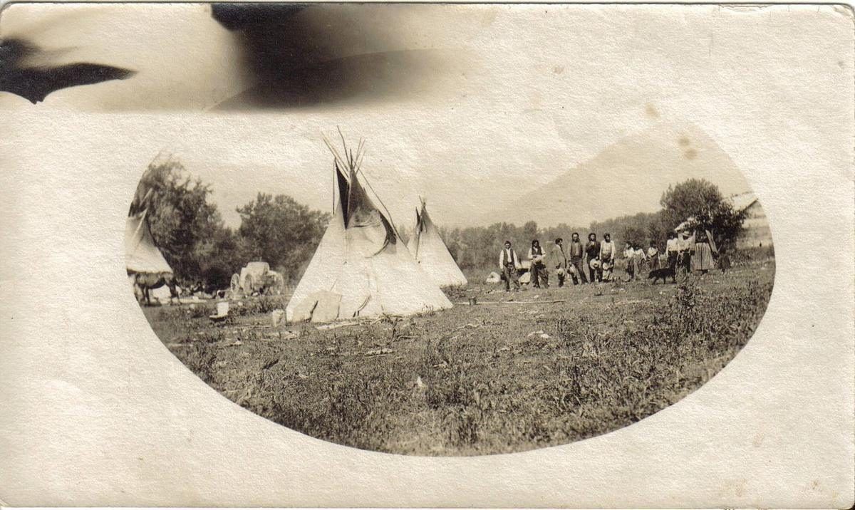 Historical photograph of a Kootenai Tribe encampment with teepees, from the Boundary County Museum collection
