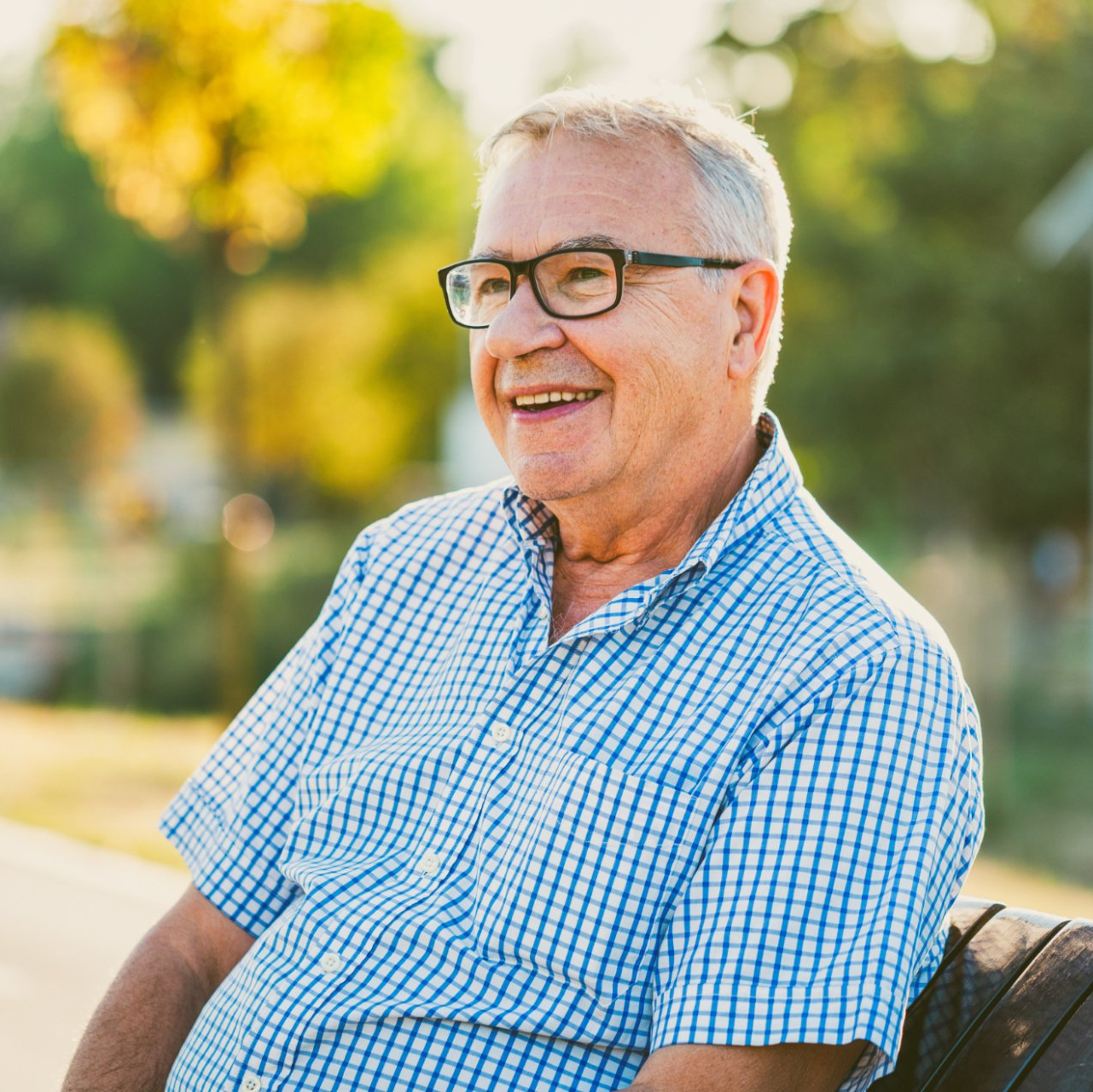 smiling elderly caucasian man on bench