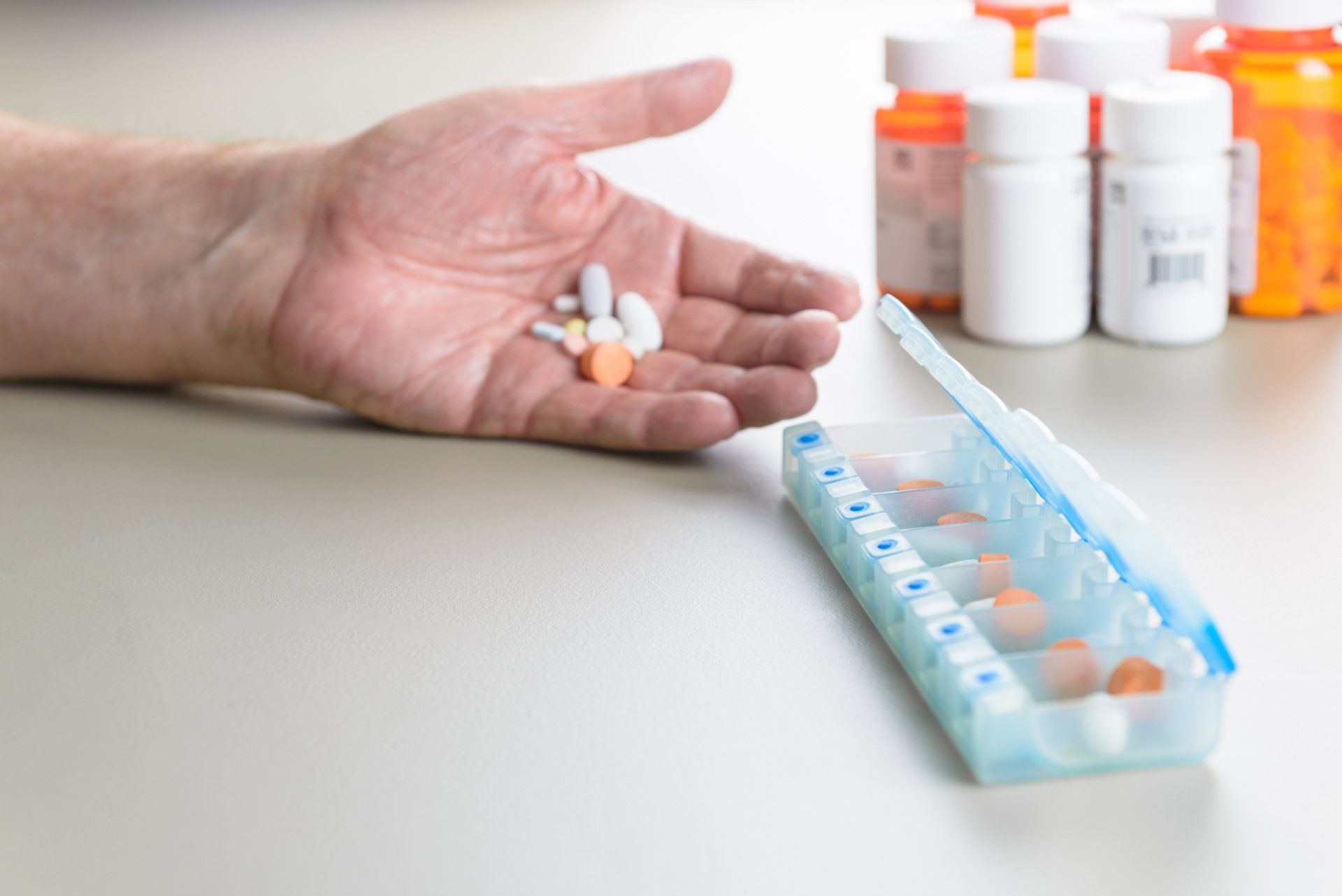 elderly person sorts medication