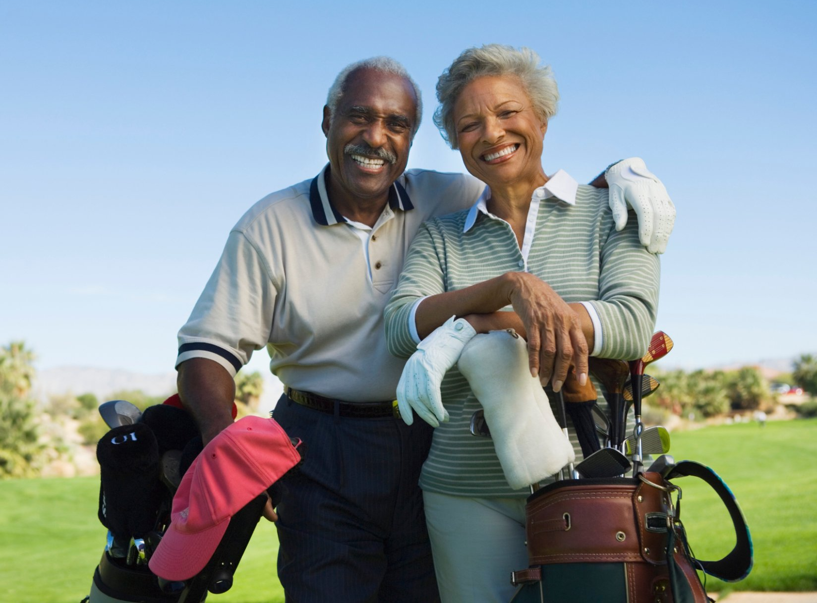 elderly couple playing golf