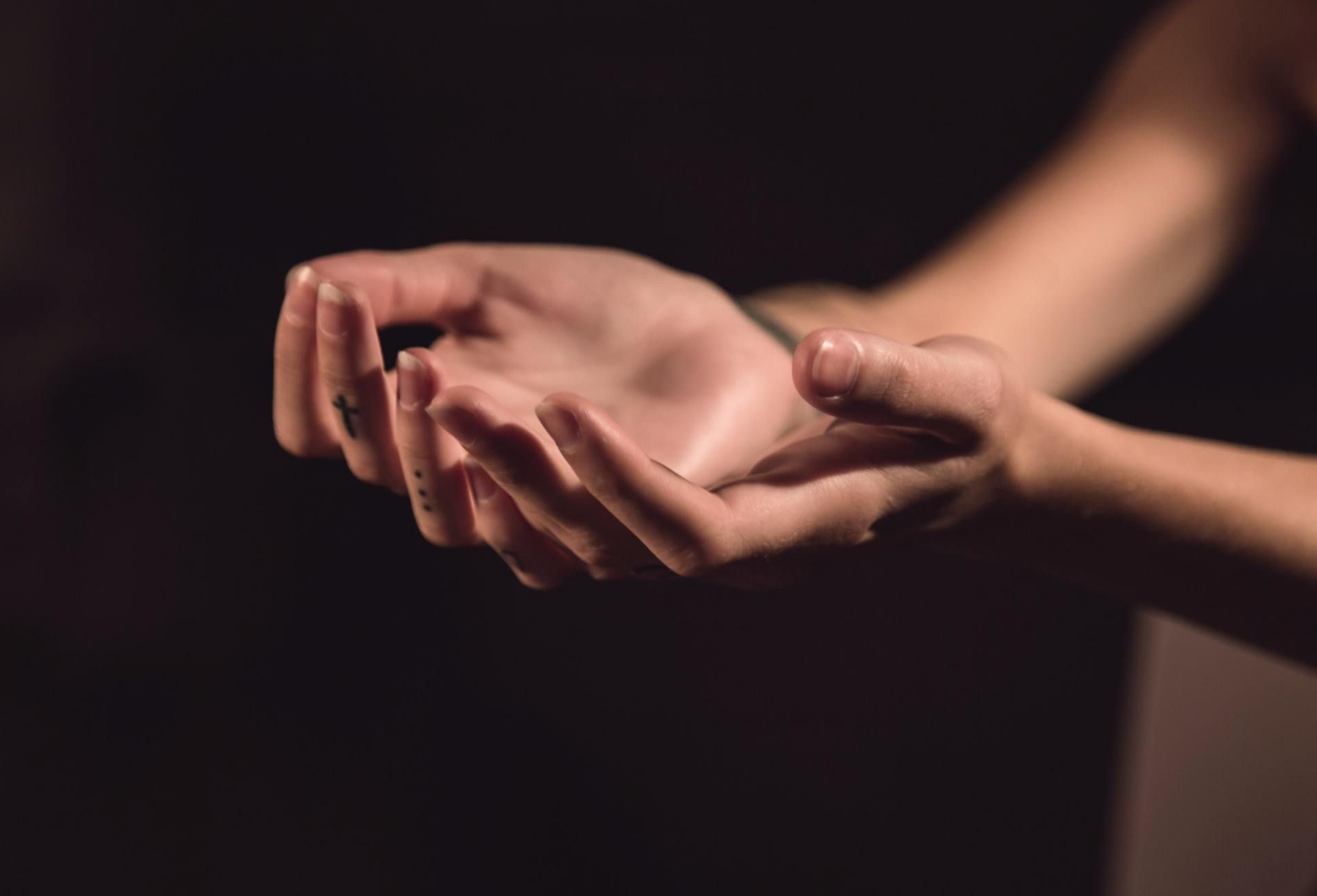 Two hands, palms up, held open