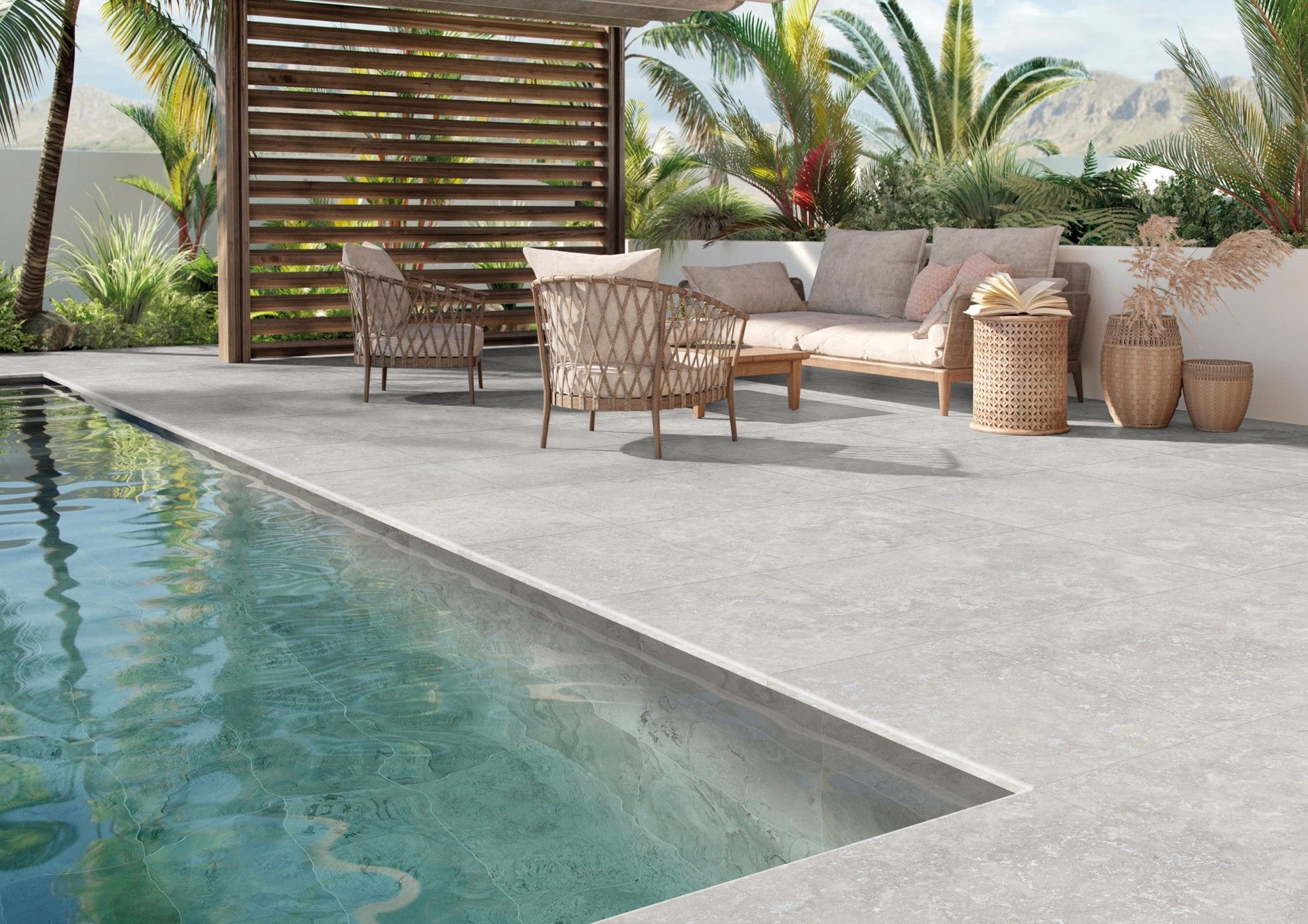 Modern poolside patio with wicker seating, neutral cushions, potted plants, and a turquoise swimming pool