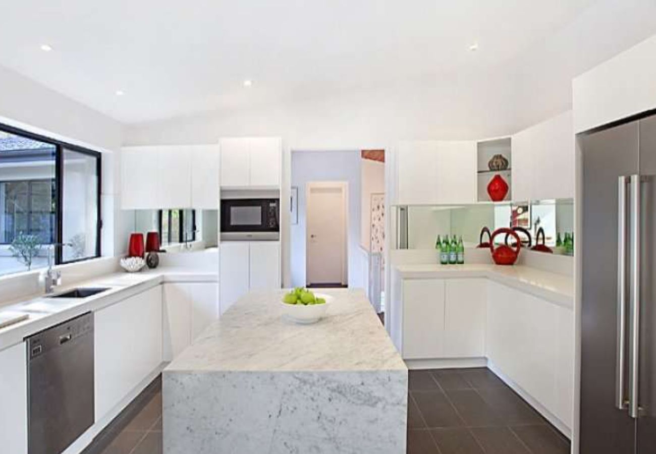 Modern White Kitchen With Island, Marble Countertops — Affordable Tiles and Pavers In Morisset, NSW