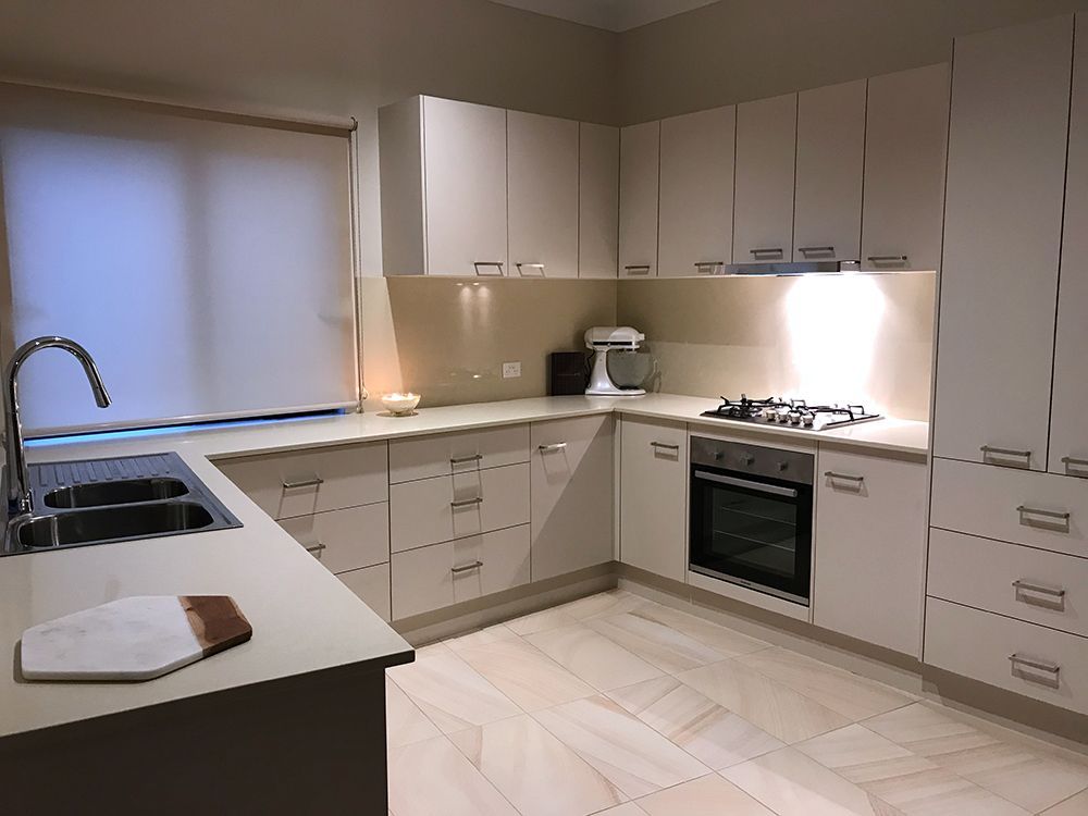 Beige Kitchen With Upper and Lower Cabinets, Stainless Steel Appliances — Affordable Tiles and Pavers In Morisset, NSW