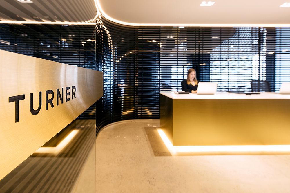 Reception Area With a Gold Front Desk, Turner Sign — Affordable Tiles and Pavers In Morisset, NSW