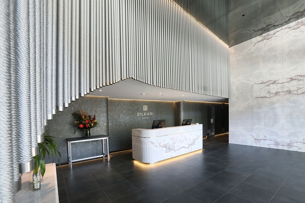 Modern Building Lobby With Marble Reception Desk and Gray Tiled Floor — Affordable Tiles and Pavers In Morisset, NSW