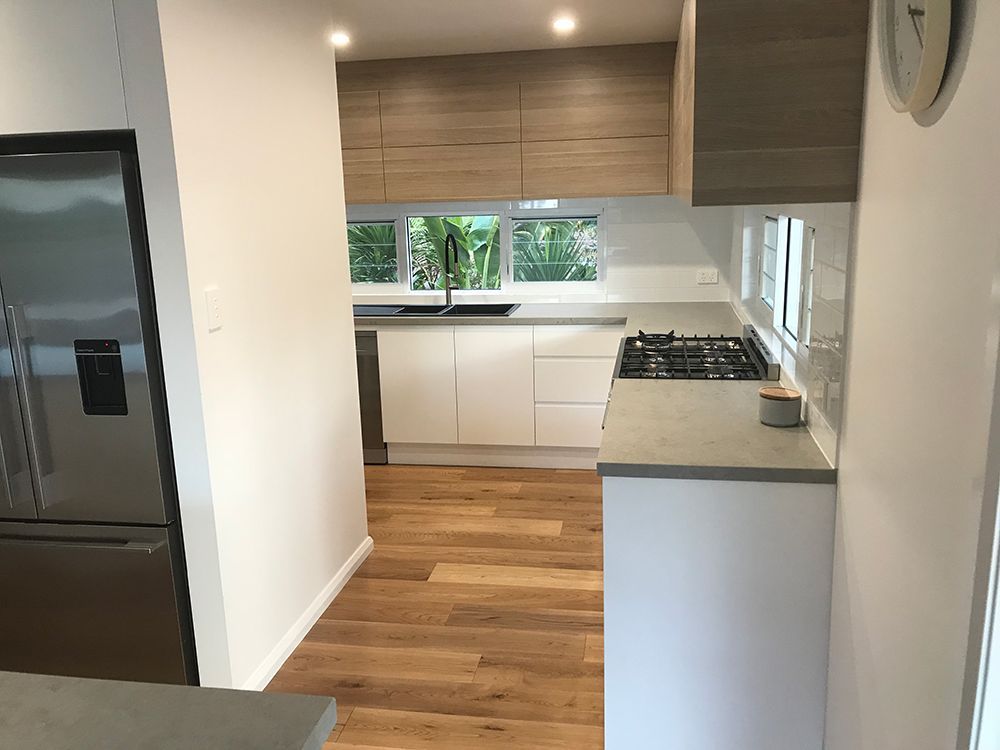 Modern Kitchen With White and Wood Cabinets, Gray Countertops — Affordable Tiles and Pavers In Morisset, NSW