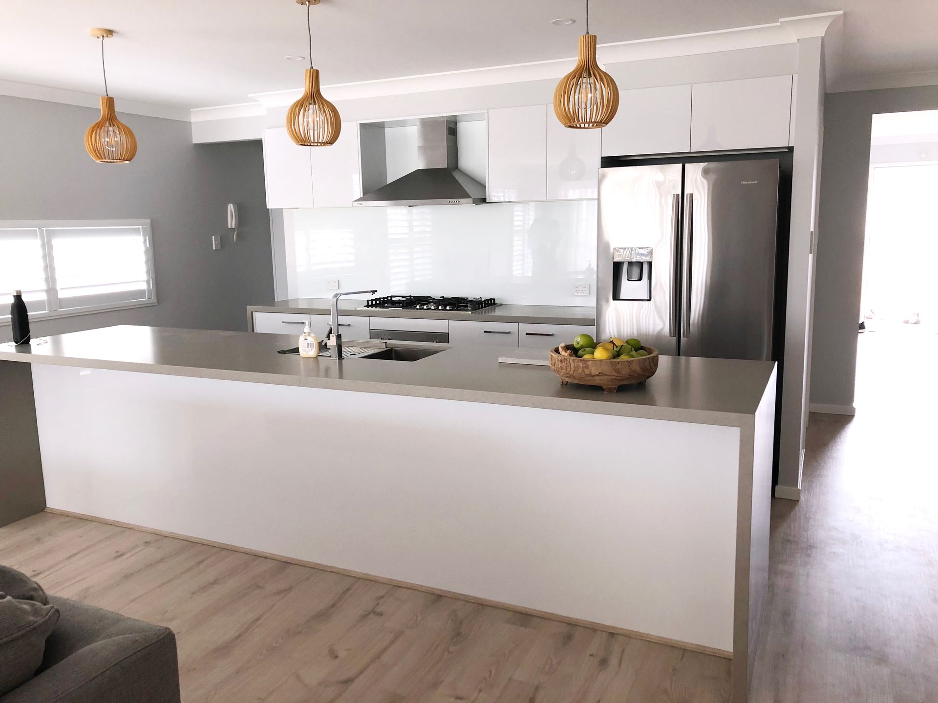 Modern Kitchen With White Cabinets, Large Island, Stainless Steel Appliances — Affordable Tiles and Pavers In Morisset, NSW