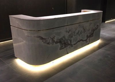 Gray Marble Reception Desk With Embedded Lighting, Set in a Modern Building — Affordable Tiles and Pavers In Morisset, NSW