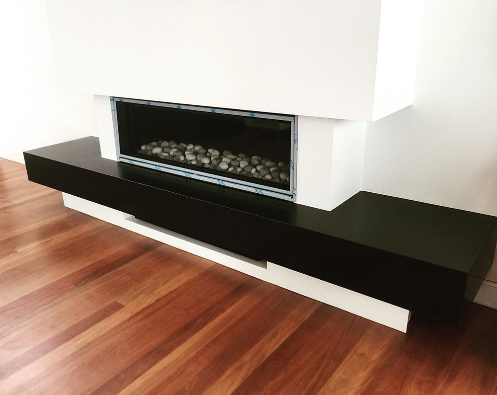 Modern Fireplace With a Black Floating Hearth on a Wood Floor, White Walls — Affordable Tiles and Pavers In Morisset, NSW