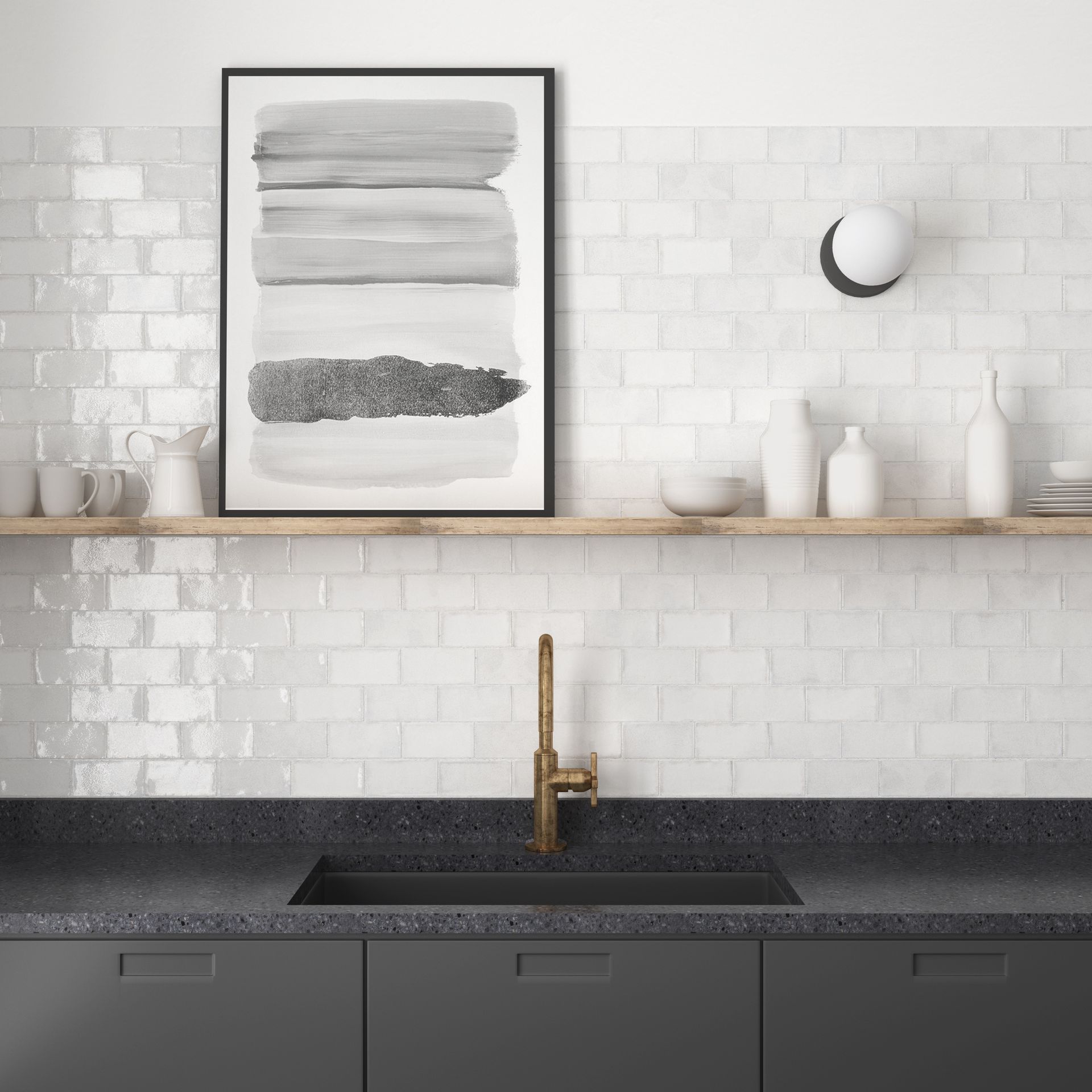 Modern kitchen with white tile backsplash, floating shelf, framed abstract art, and black countertop with brass faucet
