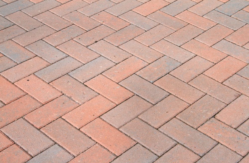 Brick Pavers Arranged in a Herringbone Pattern, With Red and Gray Tones — Affordable Tiles and Pavers In Morisset, NSW