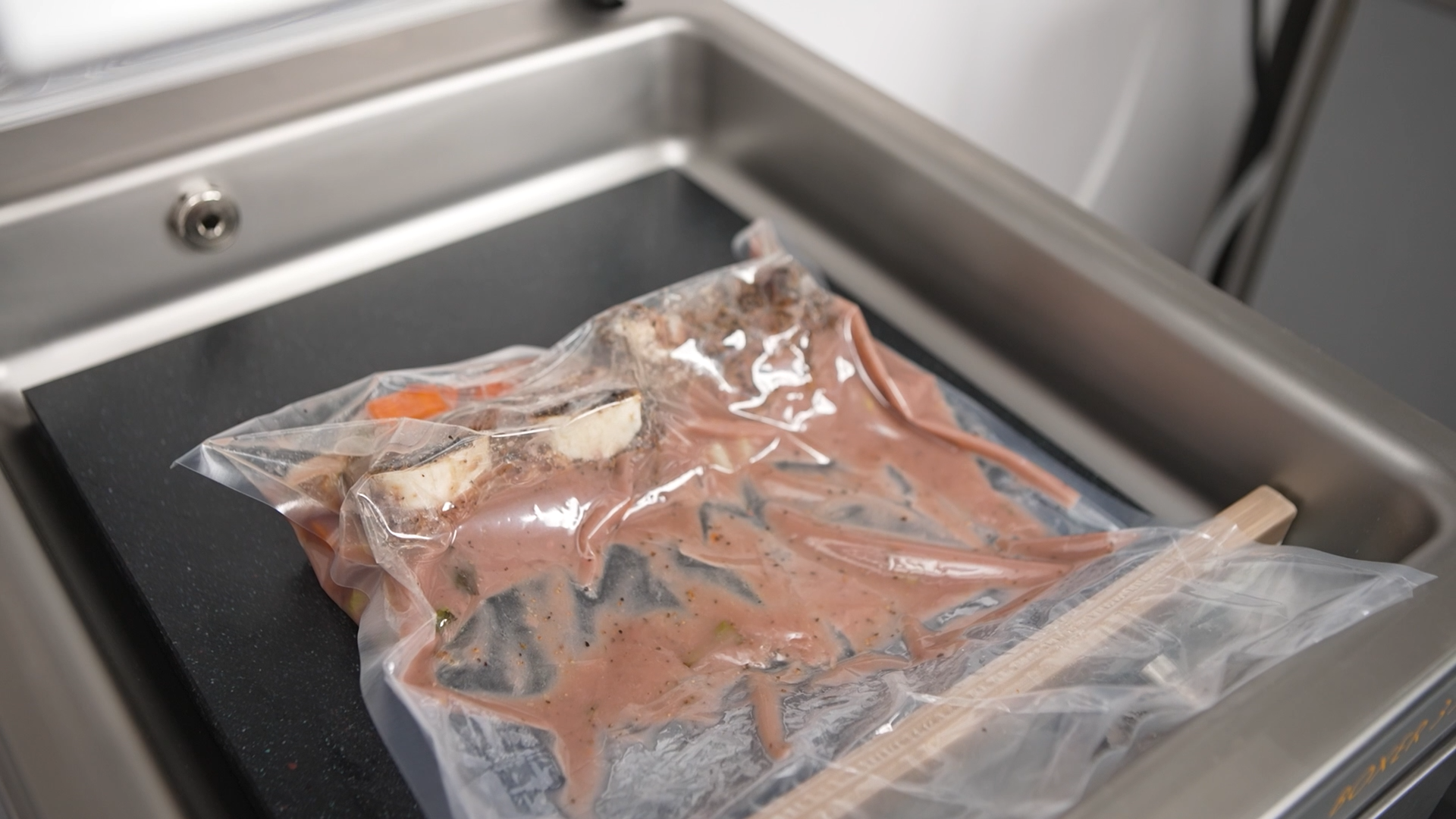 Bone-in short ribs vacuum sealed in clear bags with a Henkelman chamber vacuum sealer, ready for sous vide preparation.