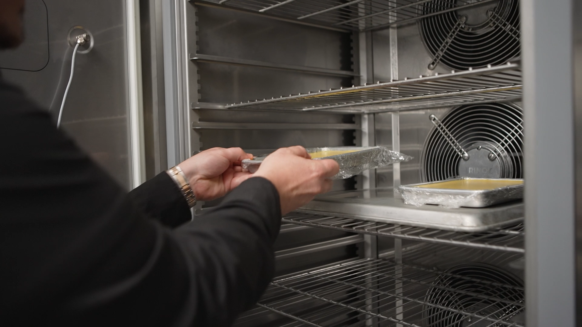 Chef Brad Kilgore placing a container of prepared fluid gel into an Irinox MultiFresh Next blast chiller.