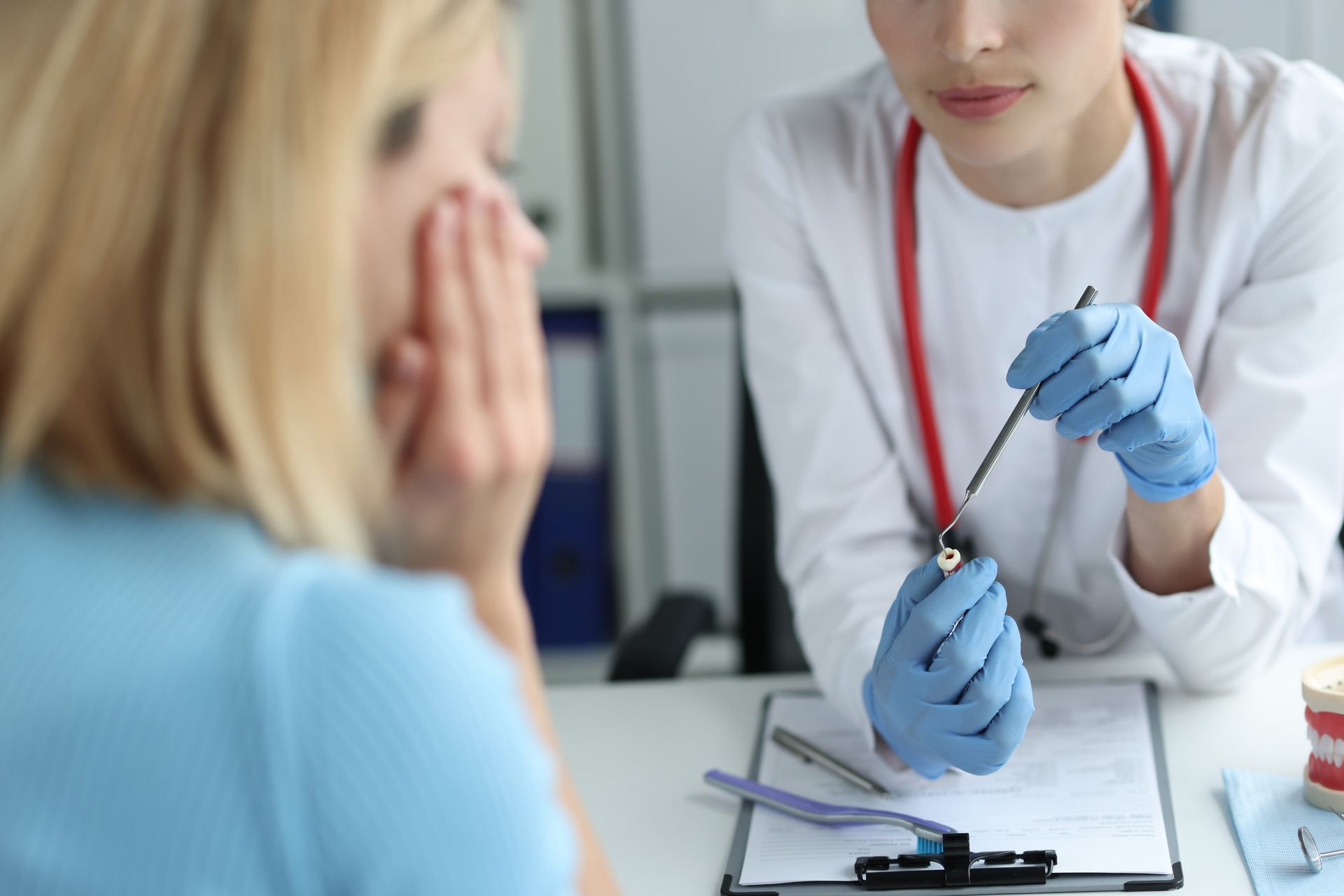 Doctor showing a blood test vial to a concerned patient in a clinic office