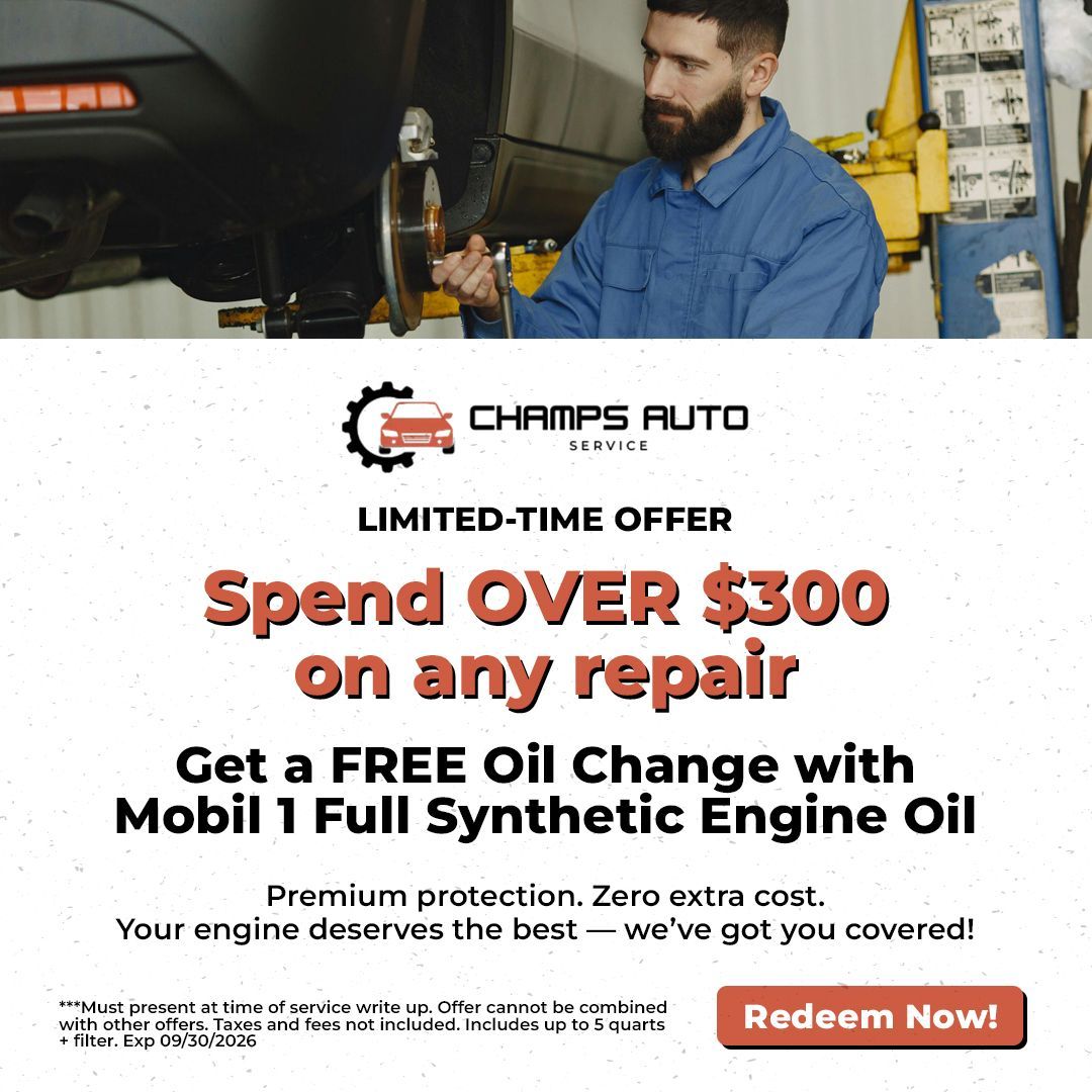 Auto repair promo: mechanic under car with text “Spend over $300 on any repair” and free oil change offer