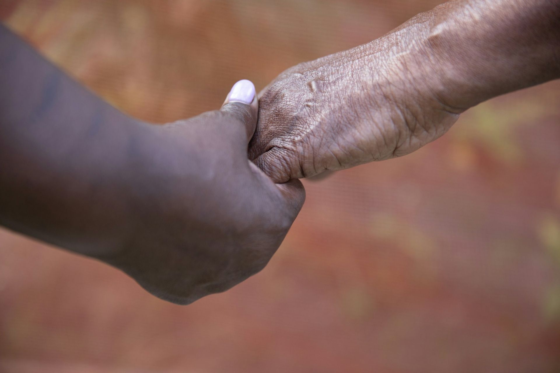 A child's hand resting gently in an elderly person's hand, reflecting the care behind planning cremation services in Tacoma.