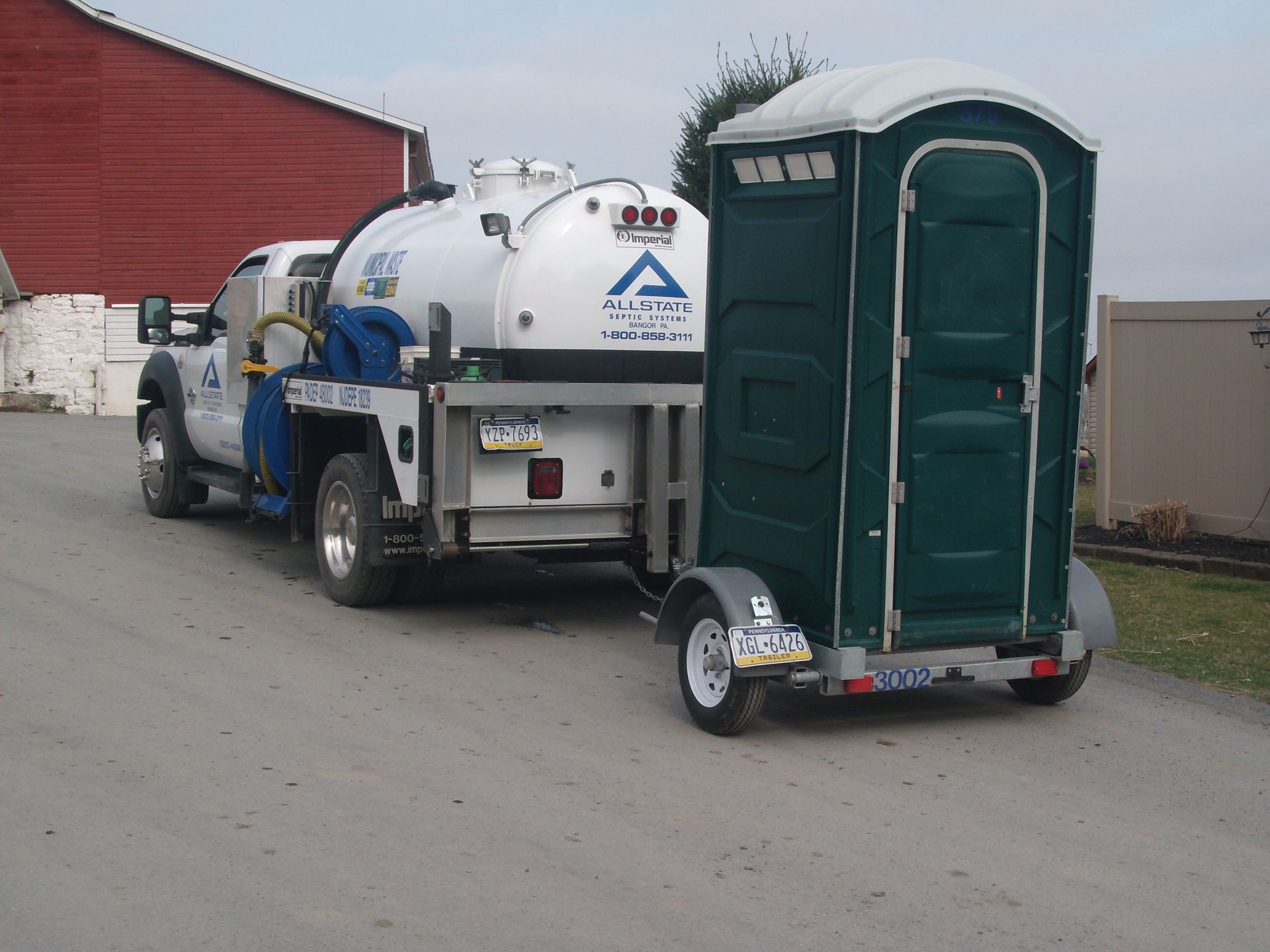 Portable restroom delivery and service trailer by Allstate Septic Systems