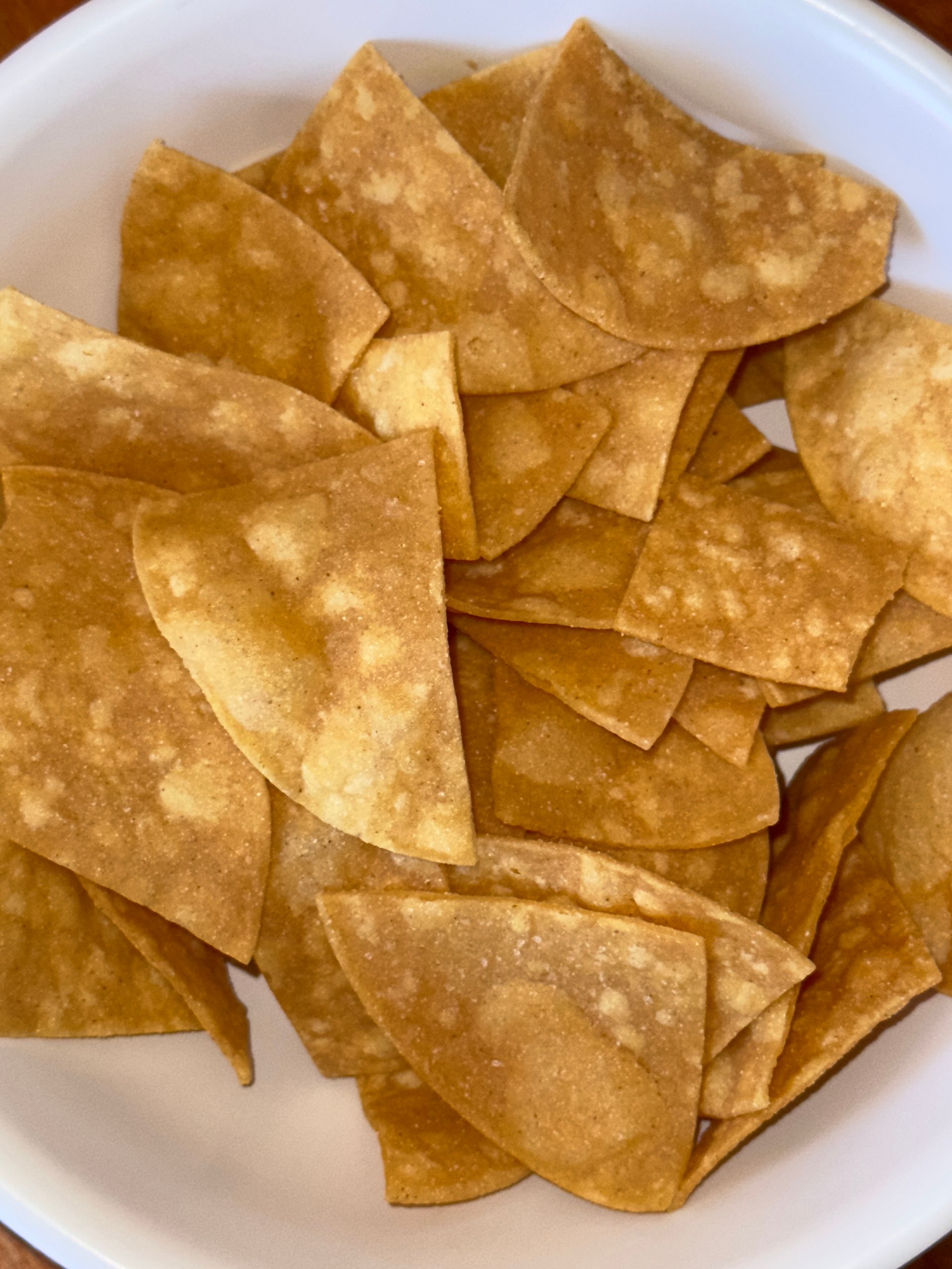 Bowl of golden-brown tortilla chips.