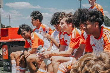 Dutch FC coaches and players on the sidelines during a match