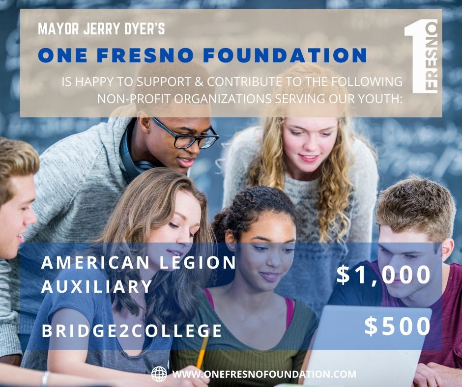 A group of young people are looking at a laptop computer.