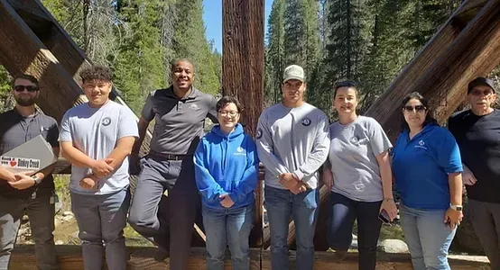 A group of people standing next to each other on a bridge.