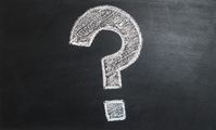 A white, hand-drawn question mark on a black chalkboard background.