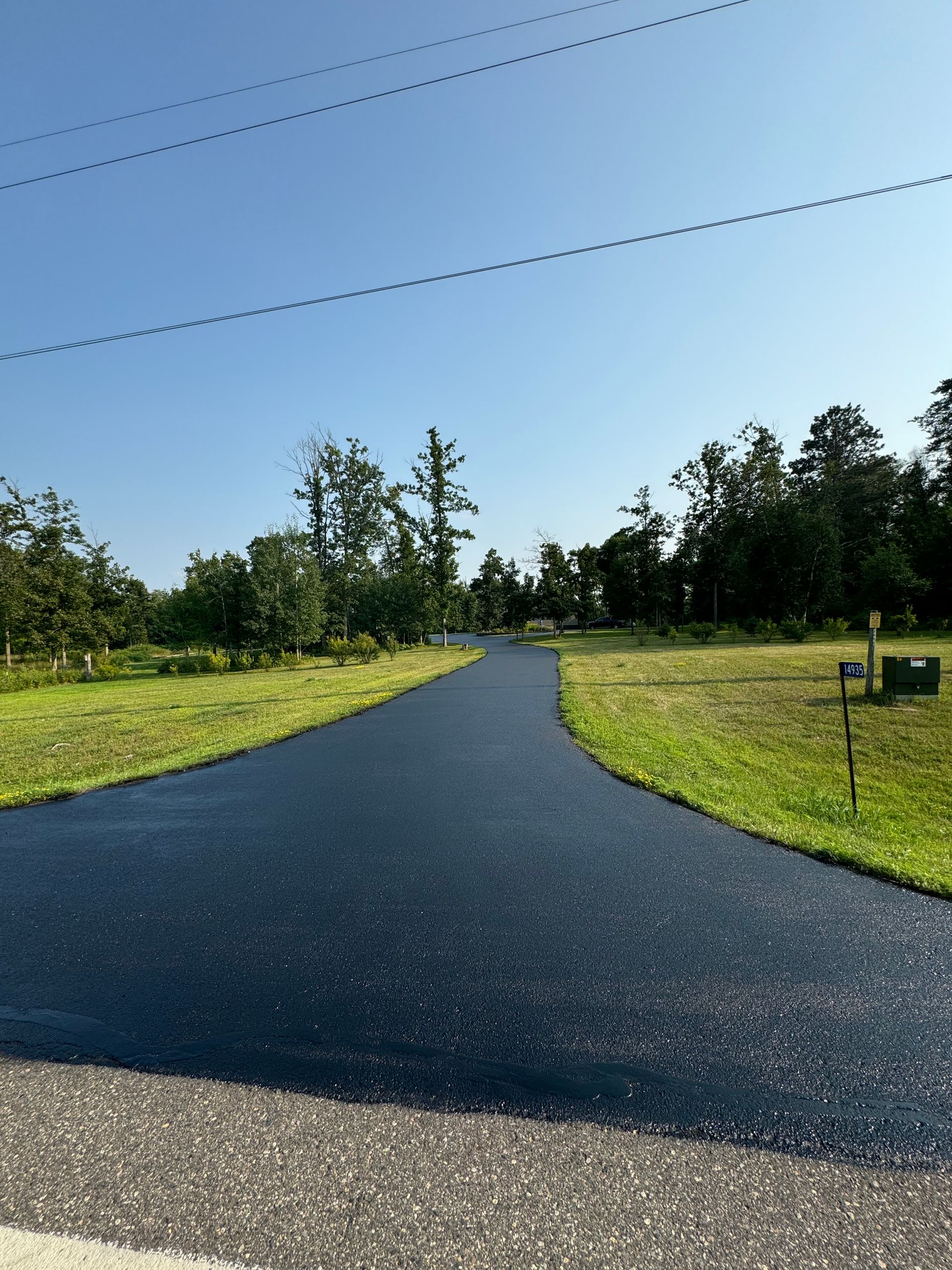 A road that is going through a grassy field