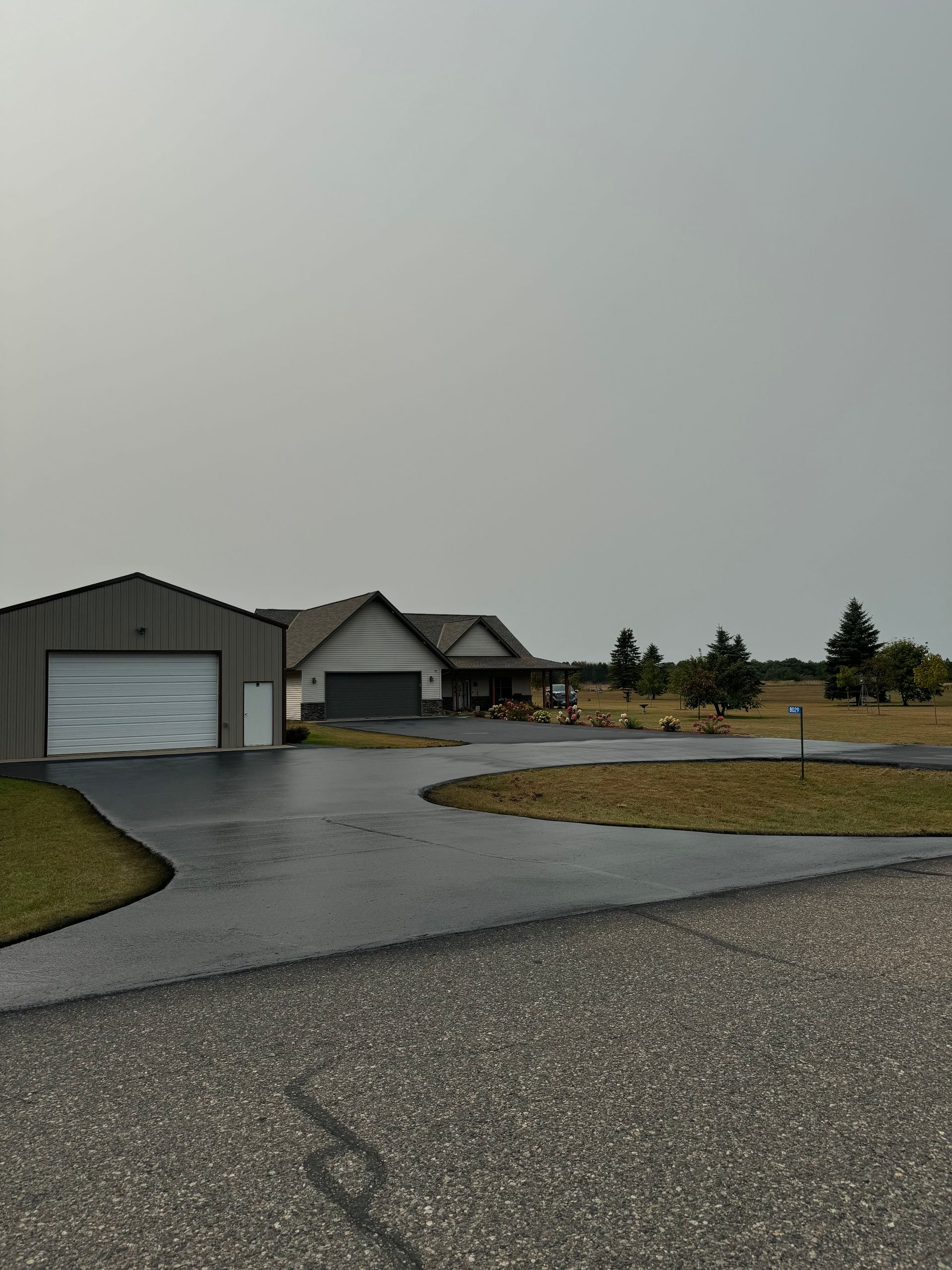A house with a garage and a driveway in front of it