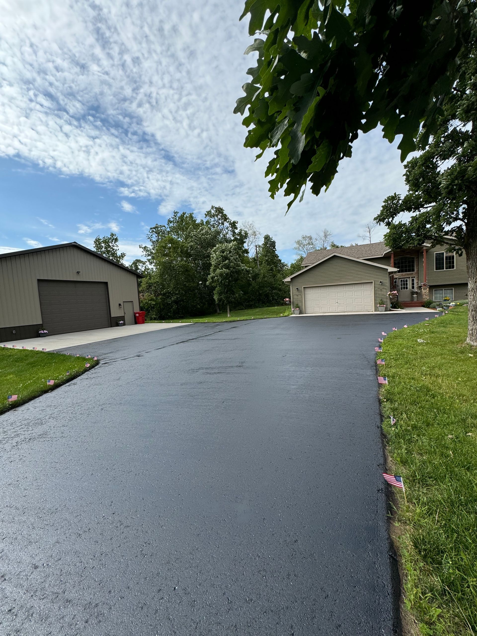 A driveway leading to a house in a residential area.
