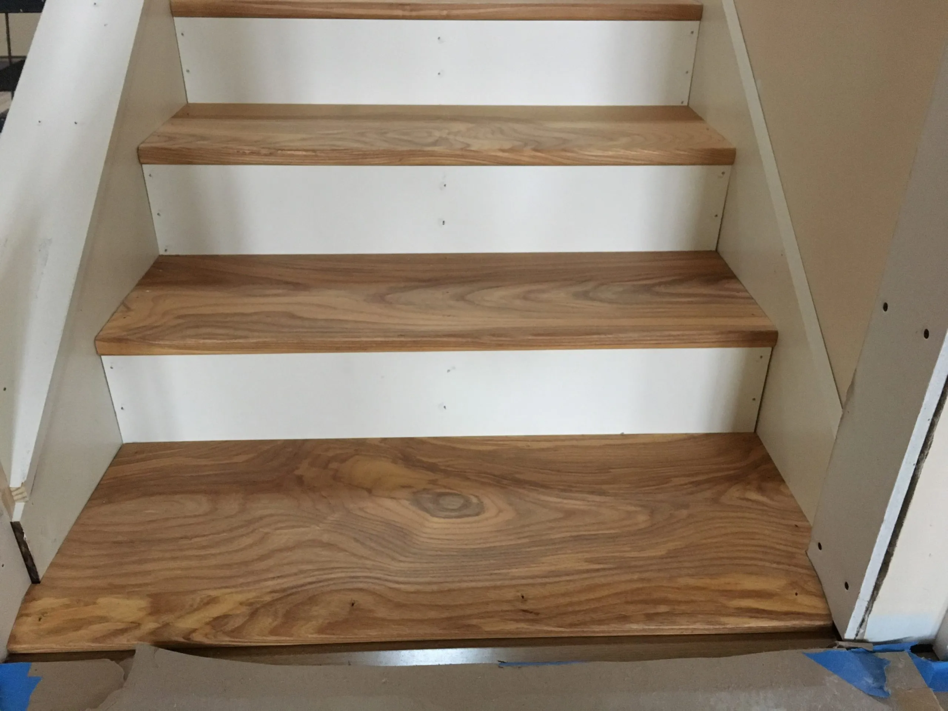 Wooden stair treads with white risers.