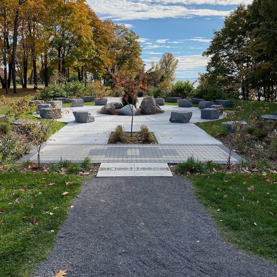 A path in a park with a tree in the middle