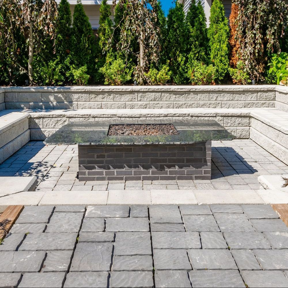 There is a fire pit in the middle of the patio.