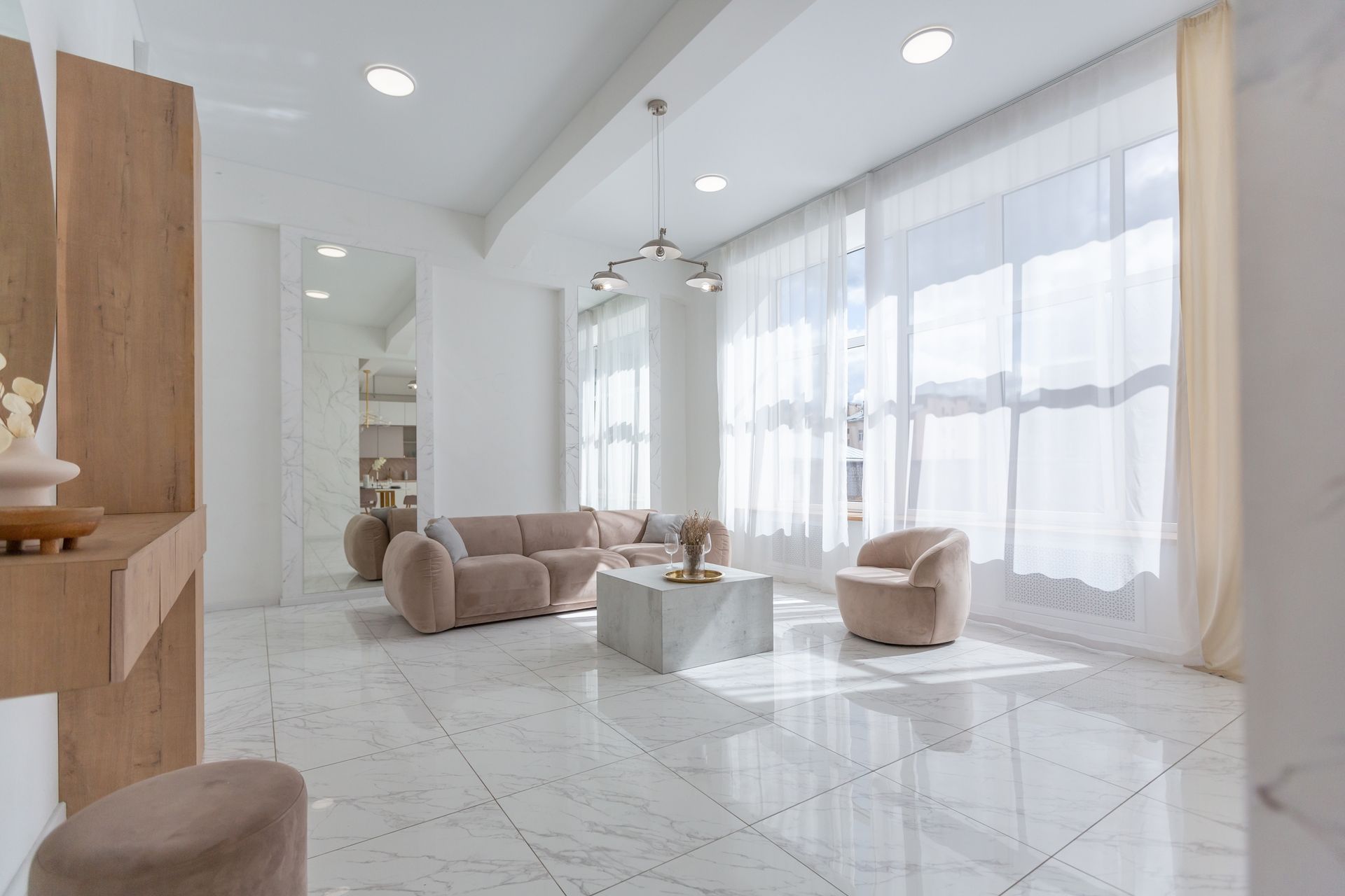 A living room with a couch , chairs , and a coffee table.